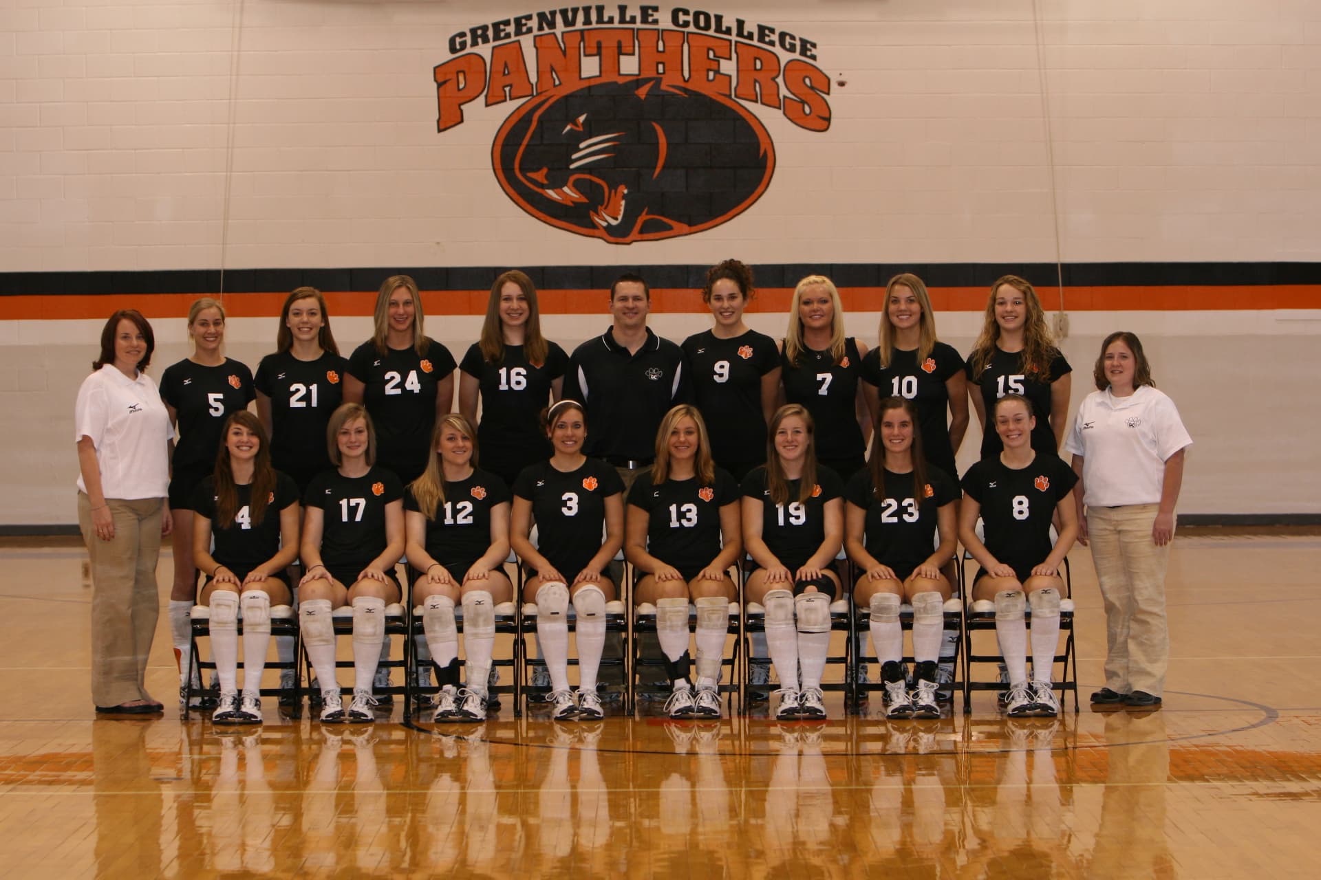 Greenville College Panthers volleyball team photo in black jerseys.